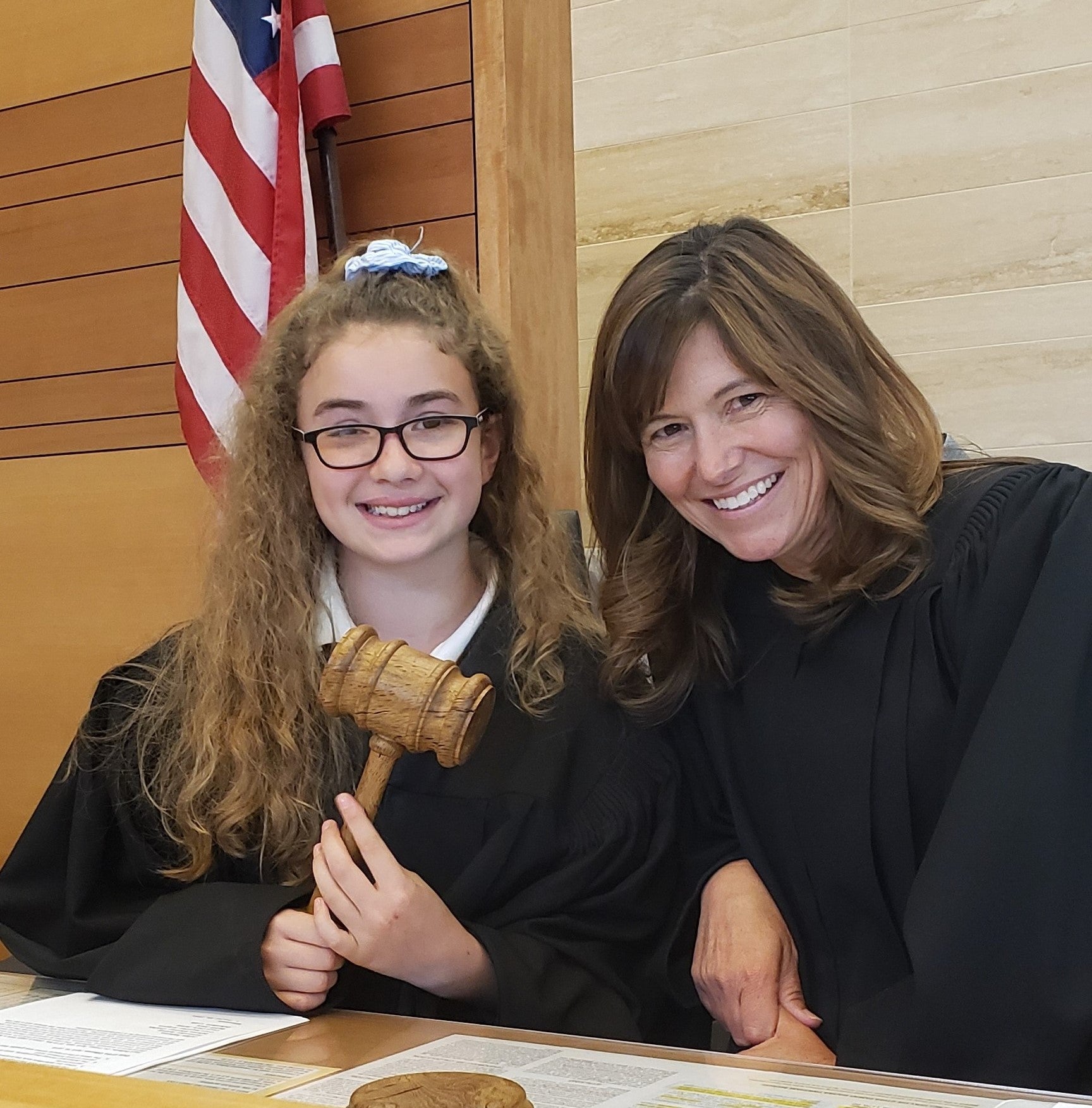 Judge Lucena on bench with young student holding gavel