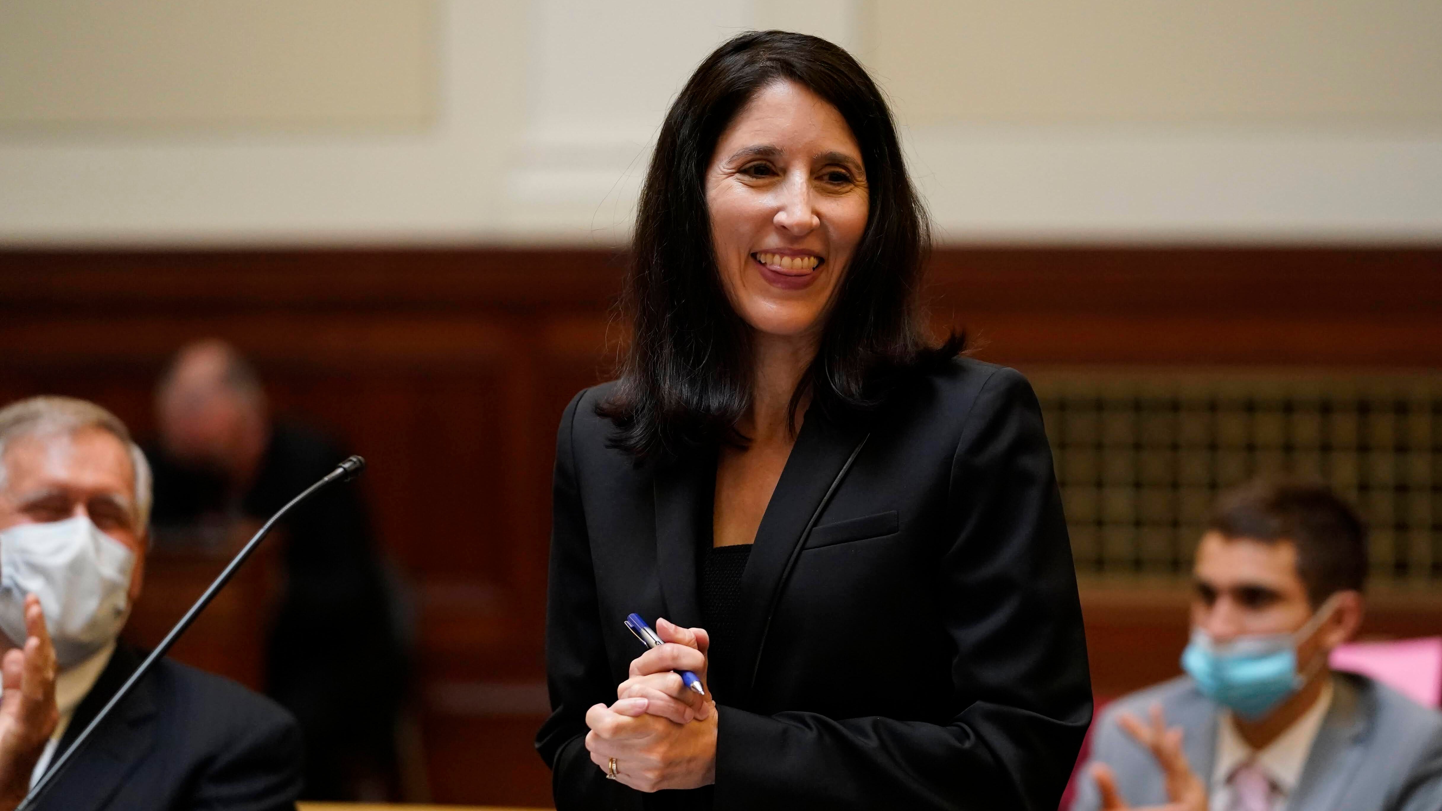 Woman standing at podium in courtroom