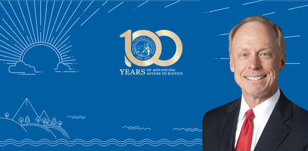 Judge Steven Jahr next to Judicial Council 100th anniversary graphic