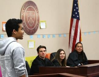 Natomas Pacific Pathways Prep student speaks in front of colleagues for peer court session.