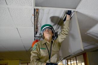California Conservation Corps members work nightly at the Stanley Mosk Courthouse in Los Angeles to retrofit the existing light fixtures to new LED lamps. Photo: Courtesy of the California Conservation Corps