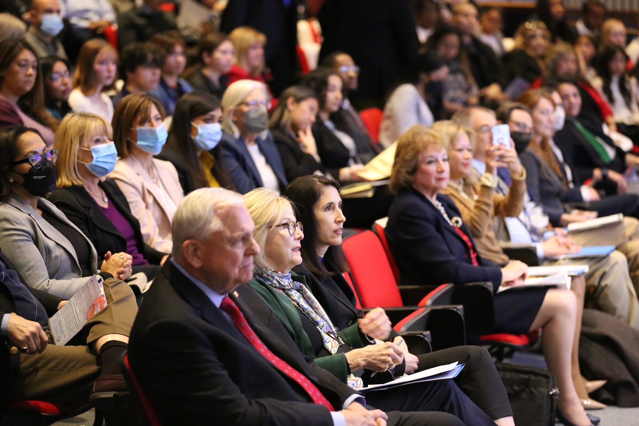 audience members at summit watching presenter