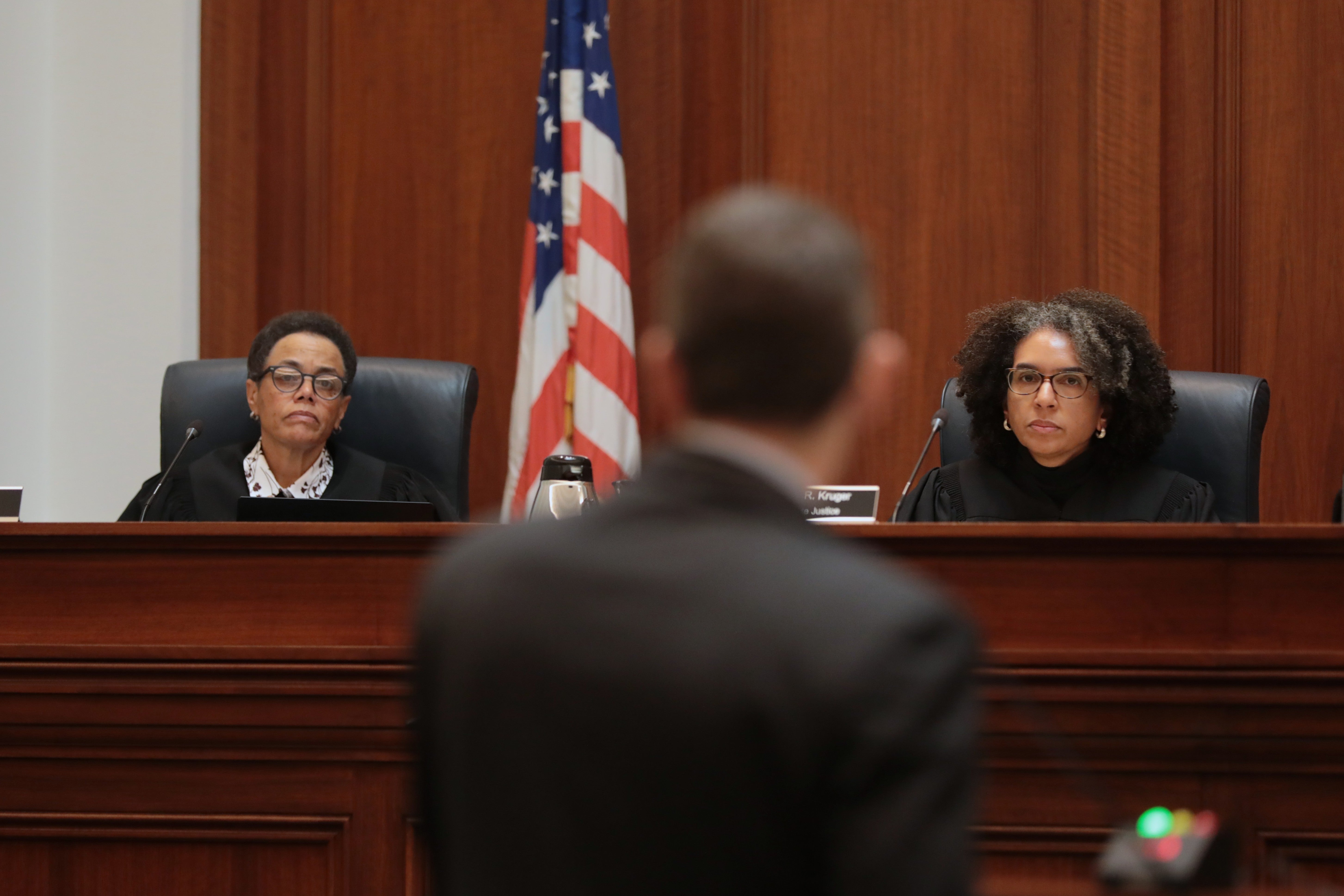 Justice Kelli Evans and Justice Leondra Kruger listen to oral argument.