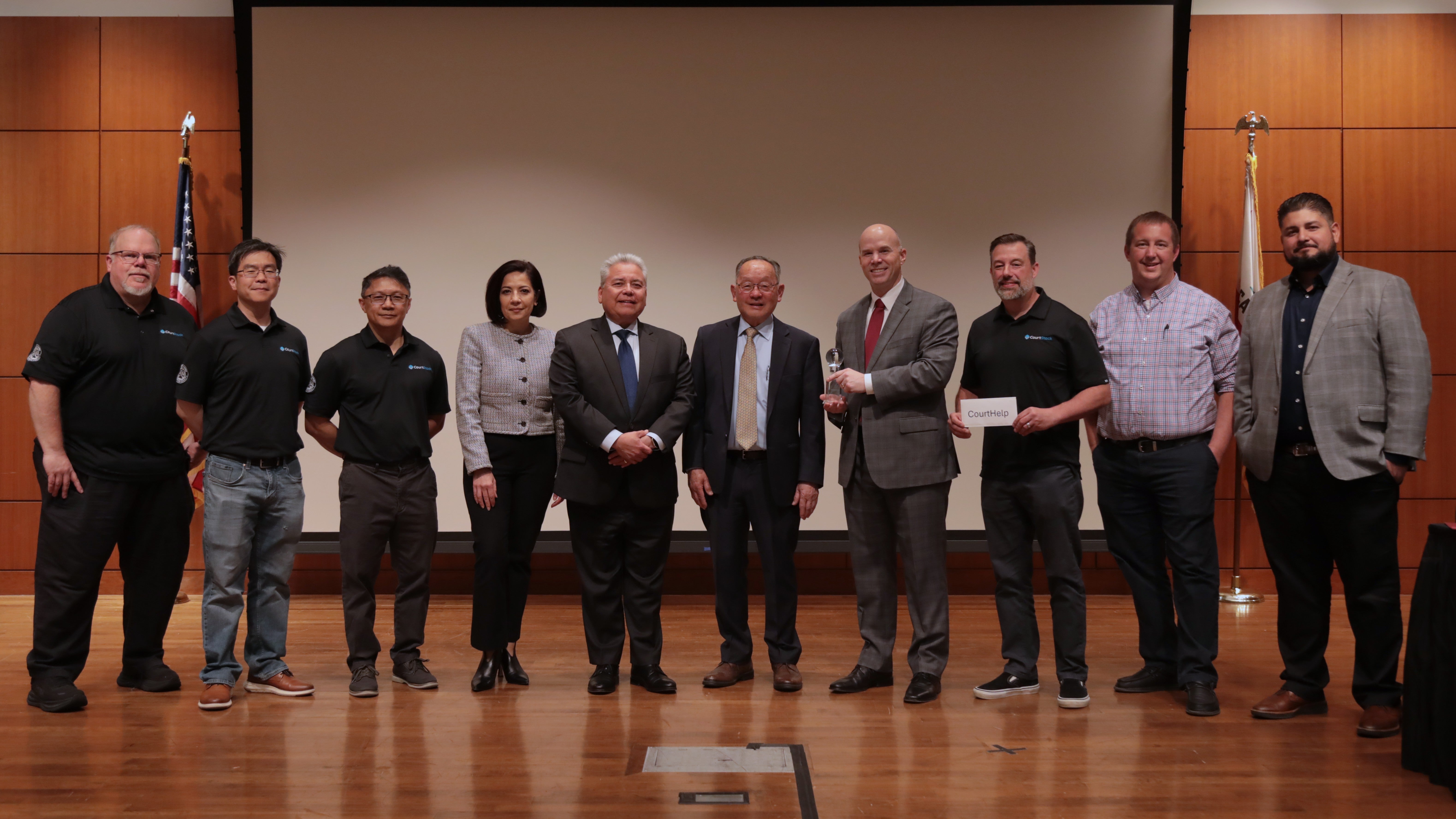 Staff from Los Angeles Superior Court stand in a row with retired Justice Ming Chin in the middle.