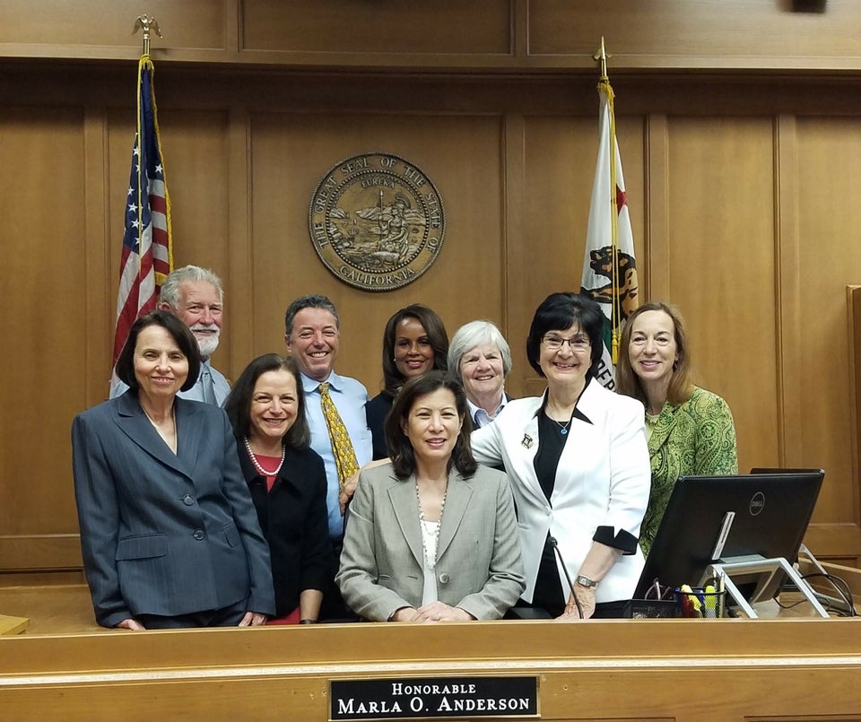 Chief Justice Tani G. Cantil-Sakauye meets with Monterey Superior Court judges. L to R: Judges Susan Matcham, Larry Hayes, Vanessa Vallarta, Sam Lavorato, Marla Anderson, Commissioner Katherine Stoner, Presiding Judge Lydia Villarreal and Assistant Presiding Judge Julie Culver. Chief Justice sitting at bench surrounded by court judges