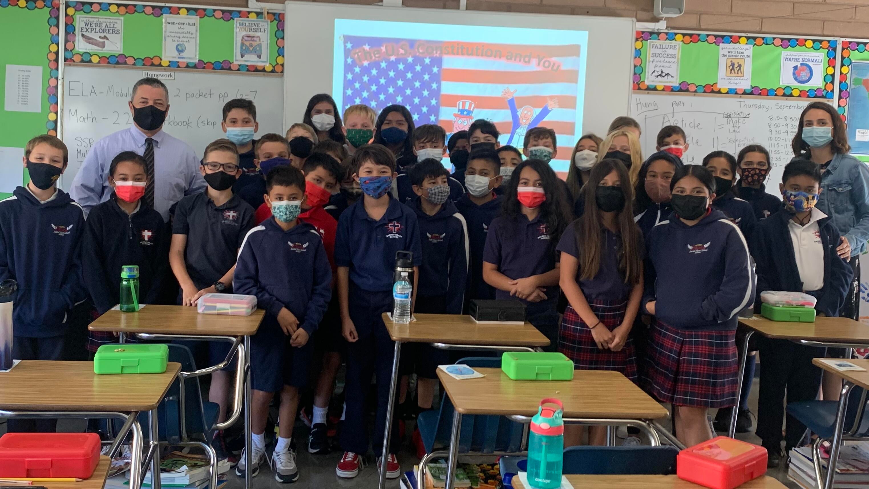 judge and teacher in classroom with group of students in classroom