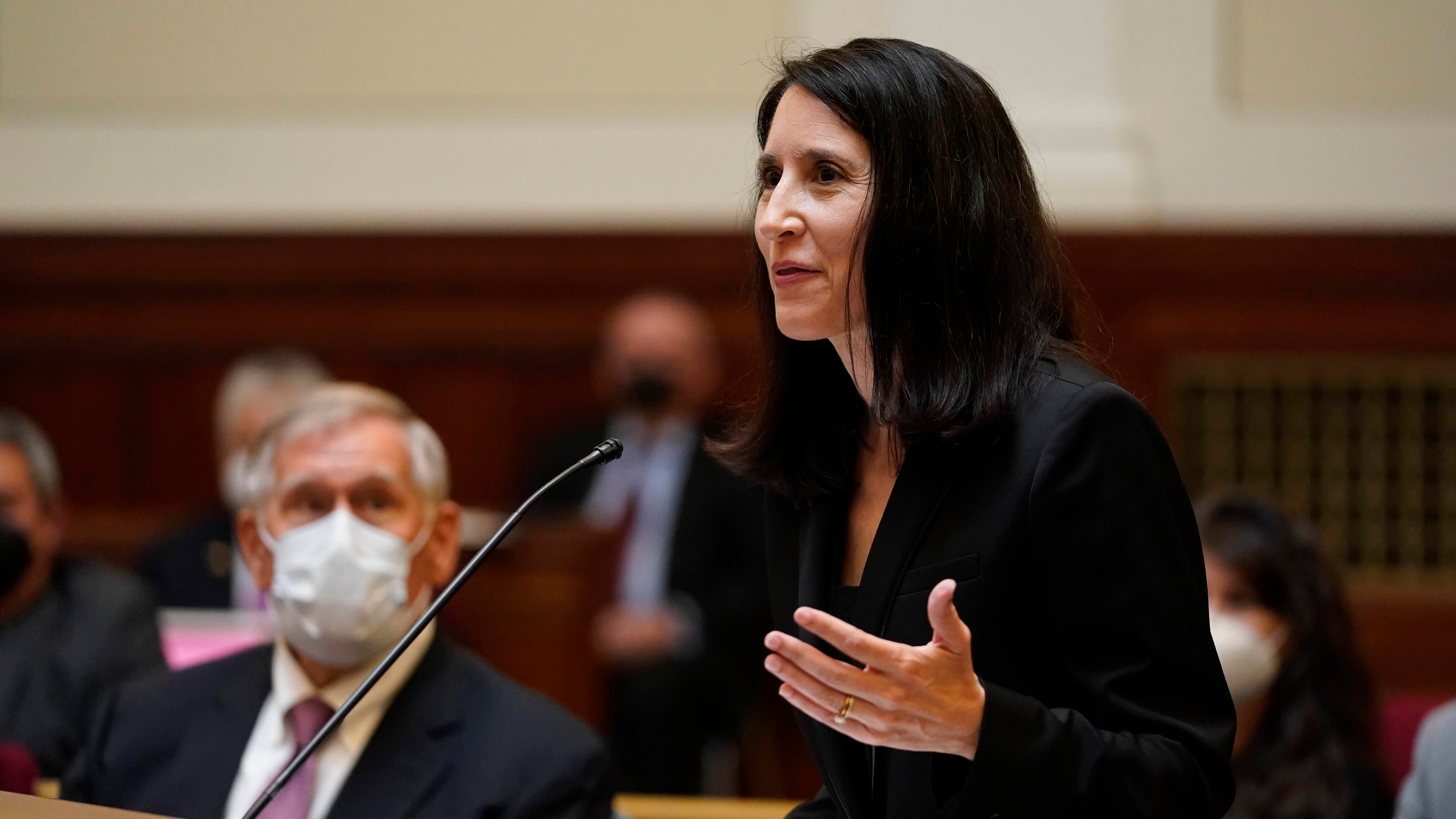 Woman standing at podium in courtroom