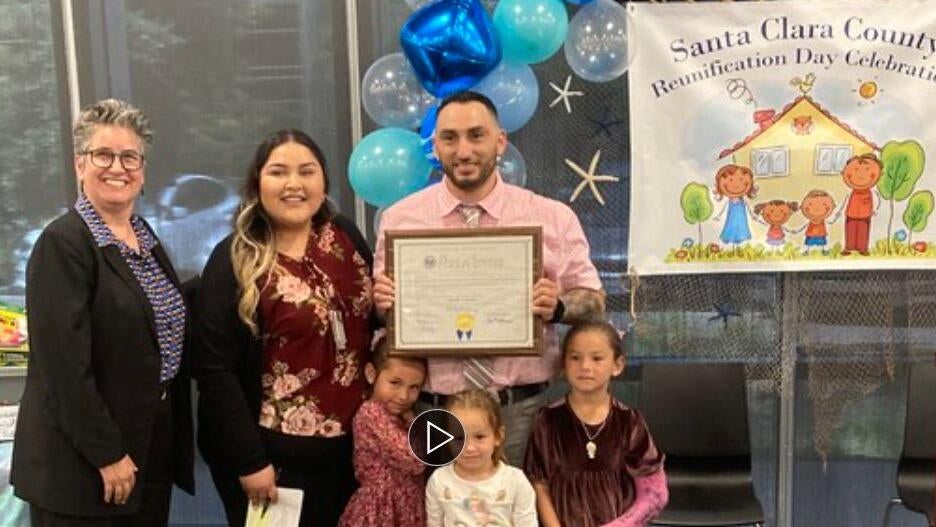 Judge stands with family at Family Reunification Day in Santa Clara County