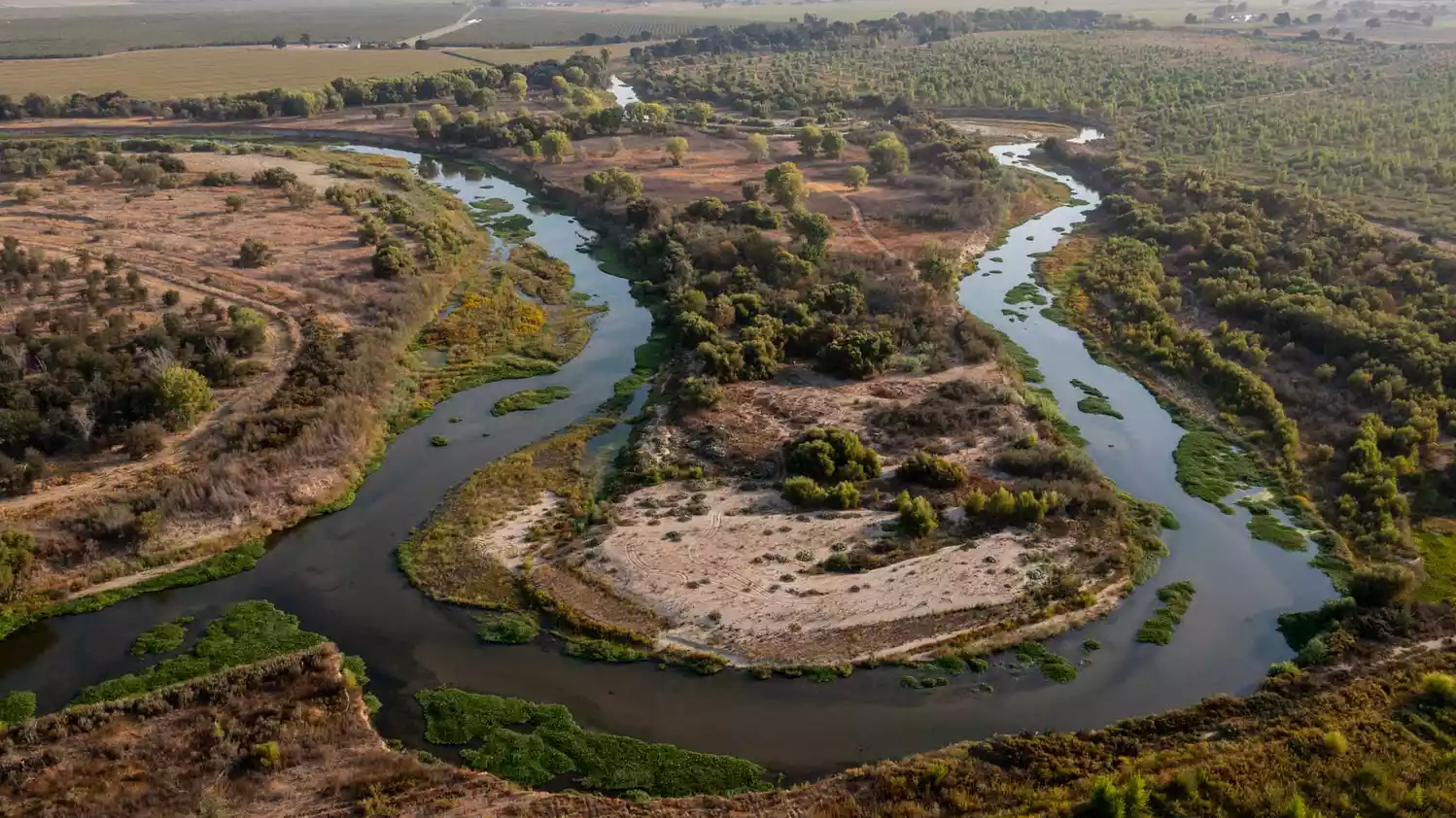 aerial view of river snaking through central valley 