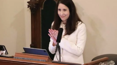 woman standing at podium giving adress
