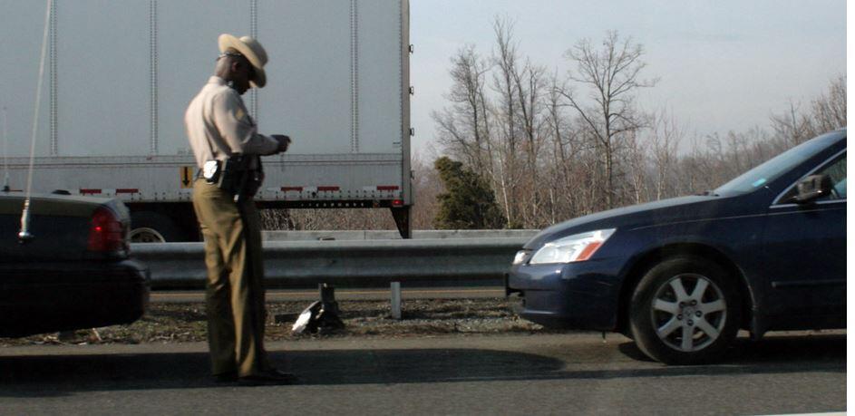 Highway patrol officer writing a ticket