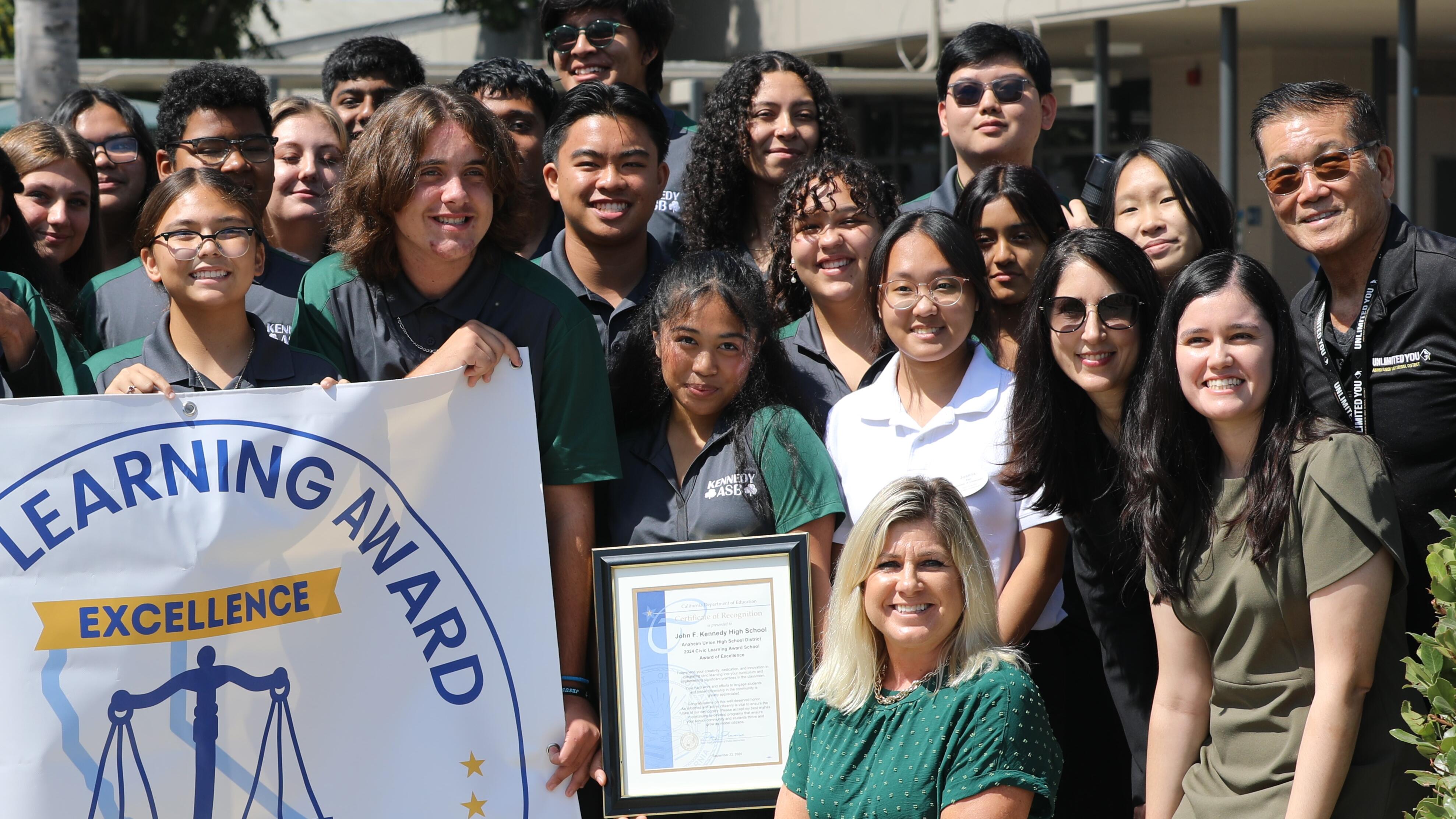 group of students with chief justice outside with Civic Learning Award banner
