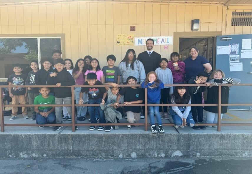 judge with elementary school students and staff