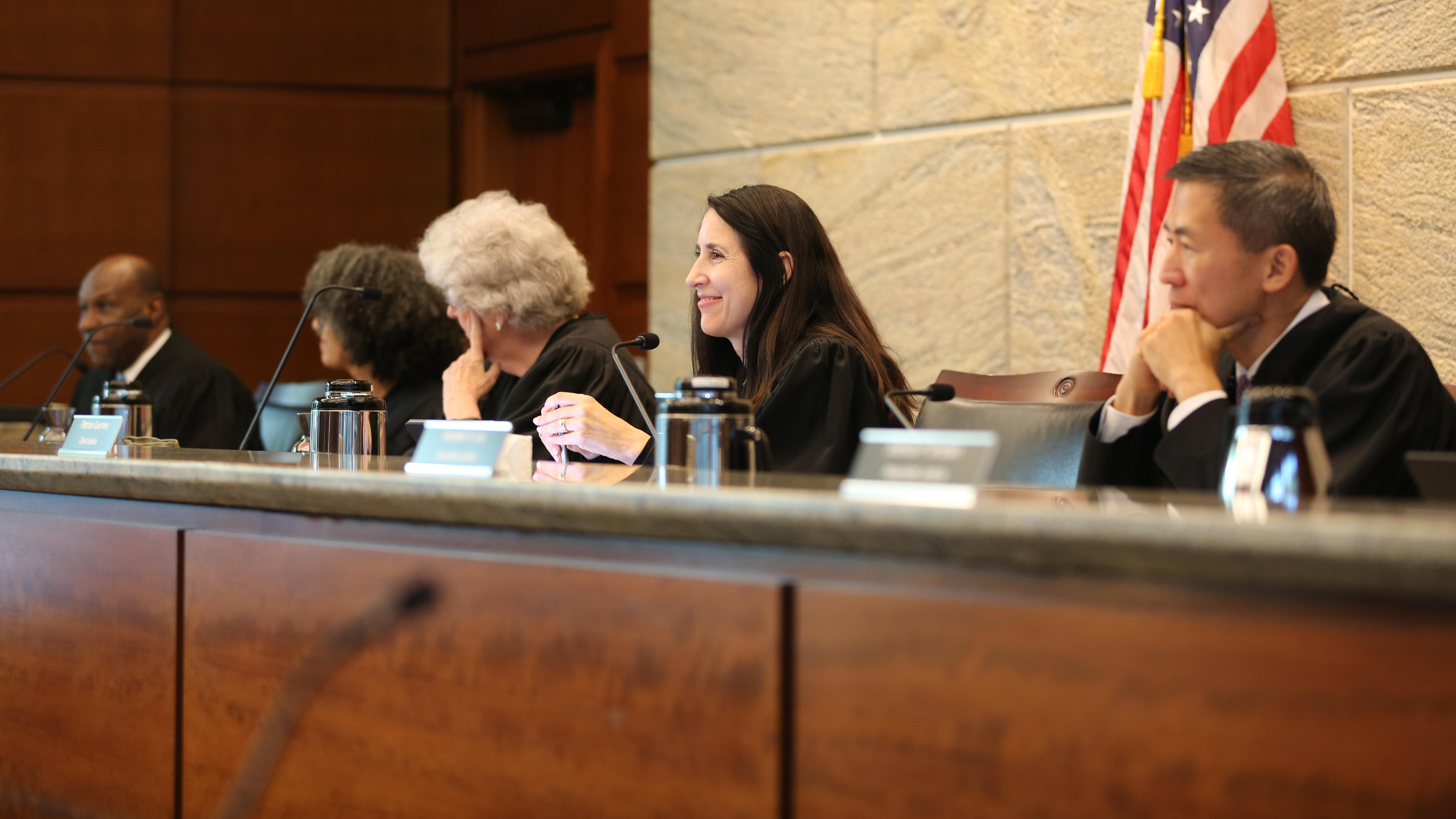 justices seated at bench listening 