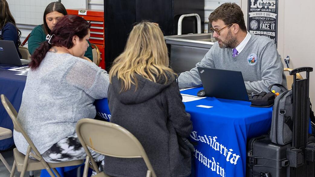 litigants and court staff at table