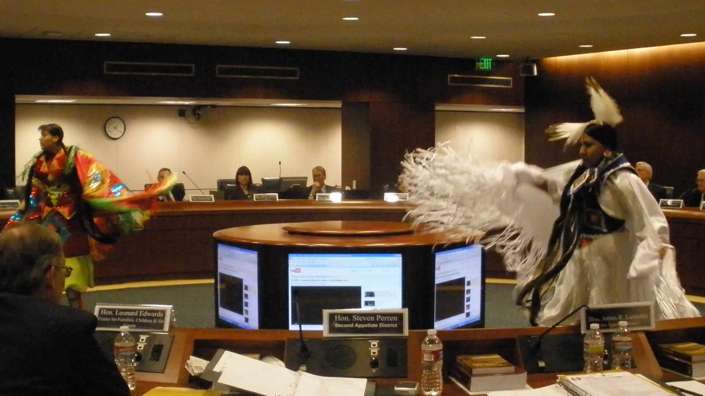 tribal dancers in boardroom
