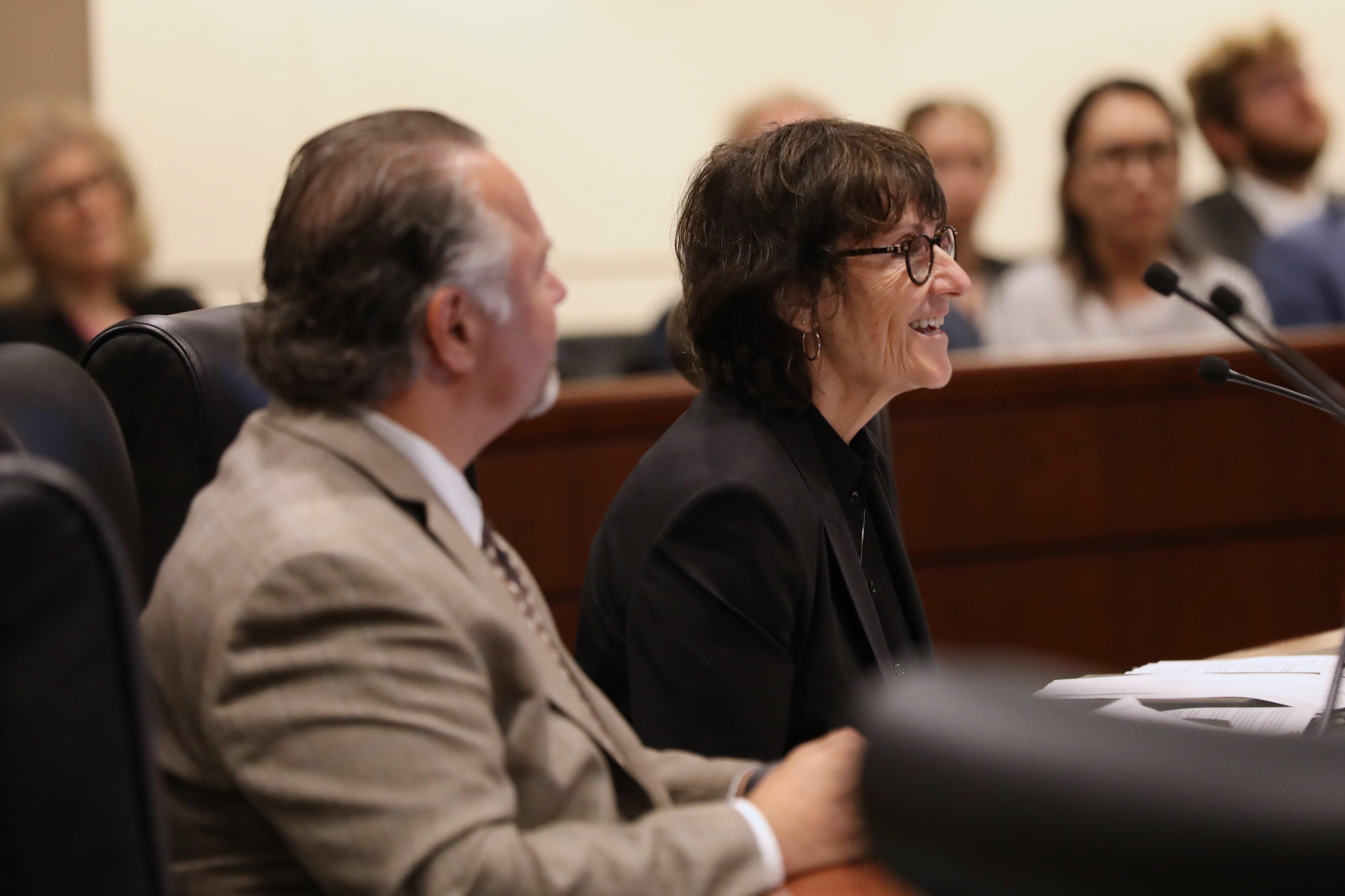 people sitting in a boardroom and one person speaking