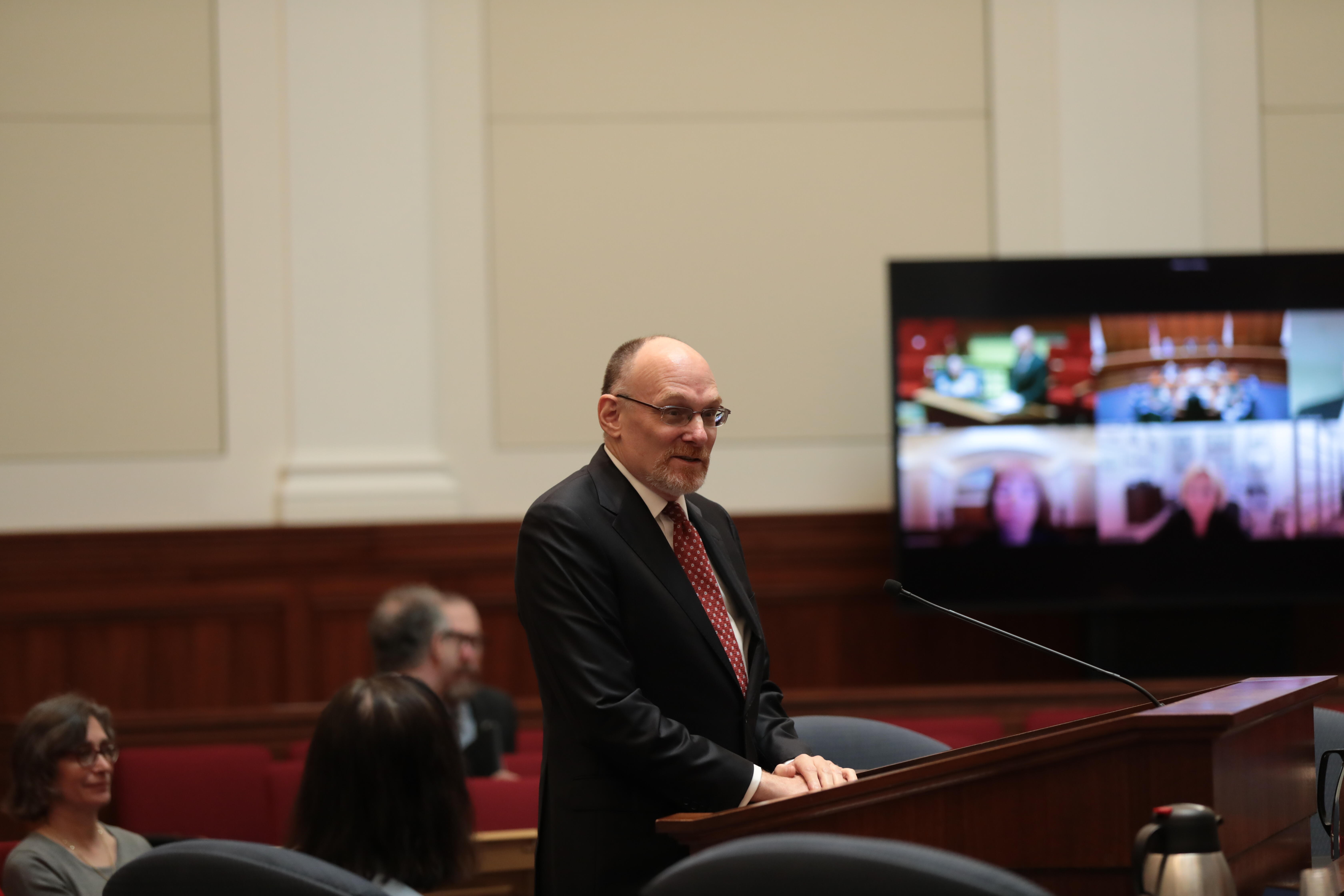 Justice Stephen Goorvitch speaks in front of a podium. 