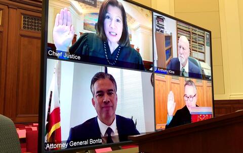 screenshot of virtual screen with oath of office raised hands