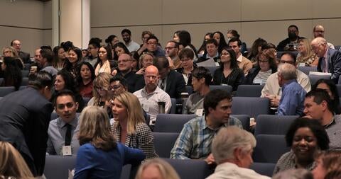 auditorium audience talking to each other