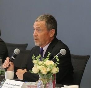 Dr. Benjamin Santer sitting at a table speaking into a microphone