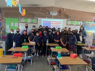 judge and teacher in classroom with group of students in classroom