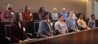 Jurors sit in a jury box inside a courtroom