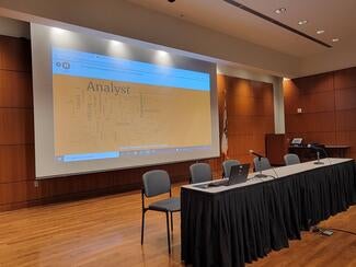 Projection screen on stage with podium