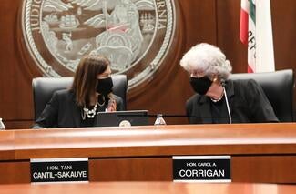 Chief Justice Tani Cantil-Sakauye and California Supreme Court Associate Justice Carol Corrigan talk in the Judicial Council boardroom