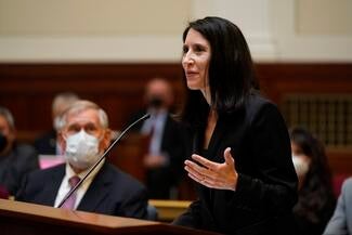 Woman standing at podium in courtroom