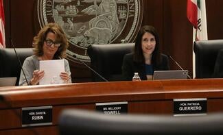 two women seated in boardroom