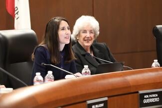 chief justice at head of boardroom with justice coorigan