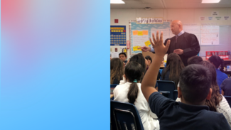 judge in classroom hand raised by student