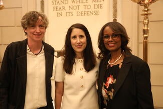 three women standing in lobby for a photo