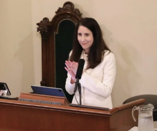 woman standing at podium giving adress