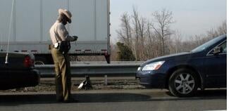 Highway patrol officer writing a ticket