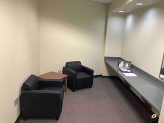 Two soft chairs and a counter inside a room