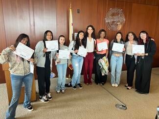 judge with students at event