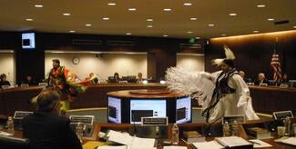 tribal dancers in boardroom