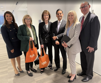 six judges standing in hallway with iCivics bags