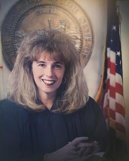 Justice Patricia Bamattre-Manoukian in judicial attire in front of United States flag and California state seal.